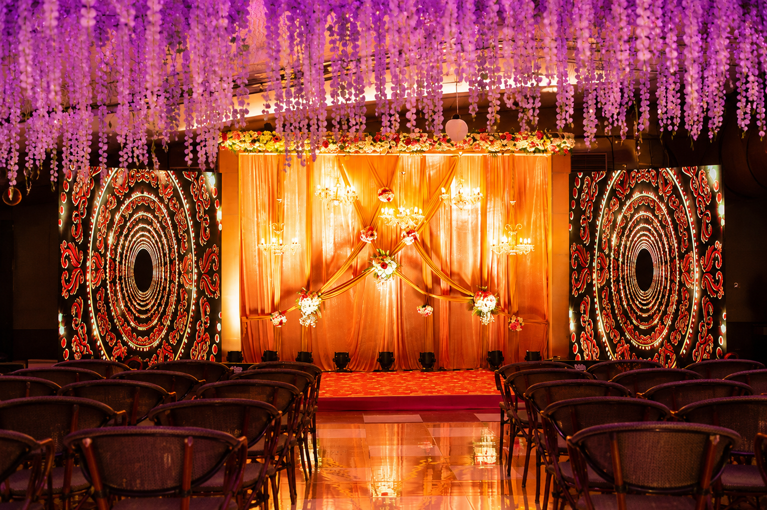 Grand indoor wedding stage with chandeliers and drapes