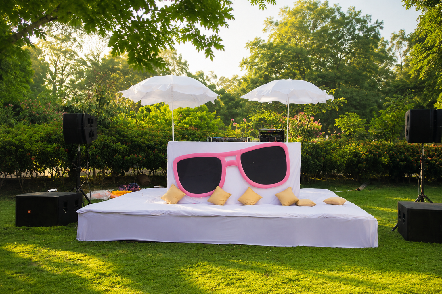Outdoor sangeet stage with playful décor and speakers