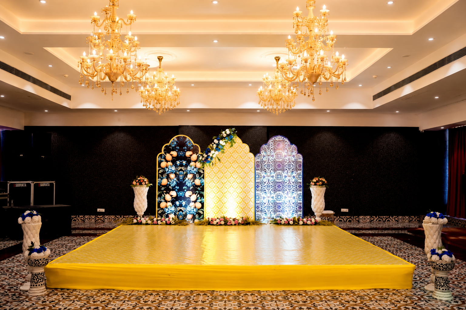 Indoor function stage with chandeliers and yellow platform