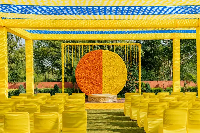 Yellow and orange marigold circular backdrop for daytime function