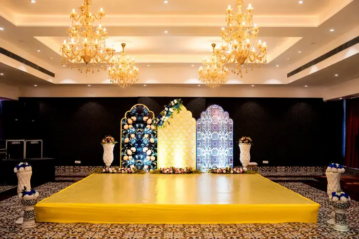 Indoor function stage with chandeliers and yellow platform